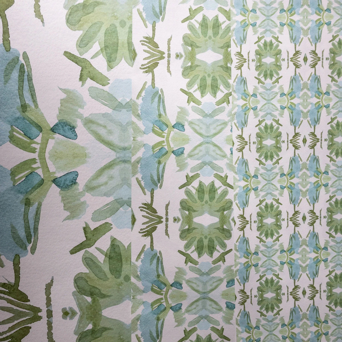 Luxury botanical wallpaper featuring an artistic wildflower-inspired pattern in sage green and soft blue, designed for modern traditional interiors, powder rooms, bedrooms, dining rooms, and collected homes.