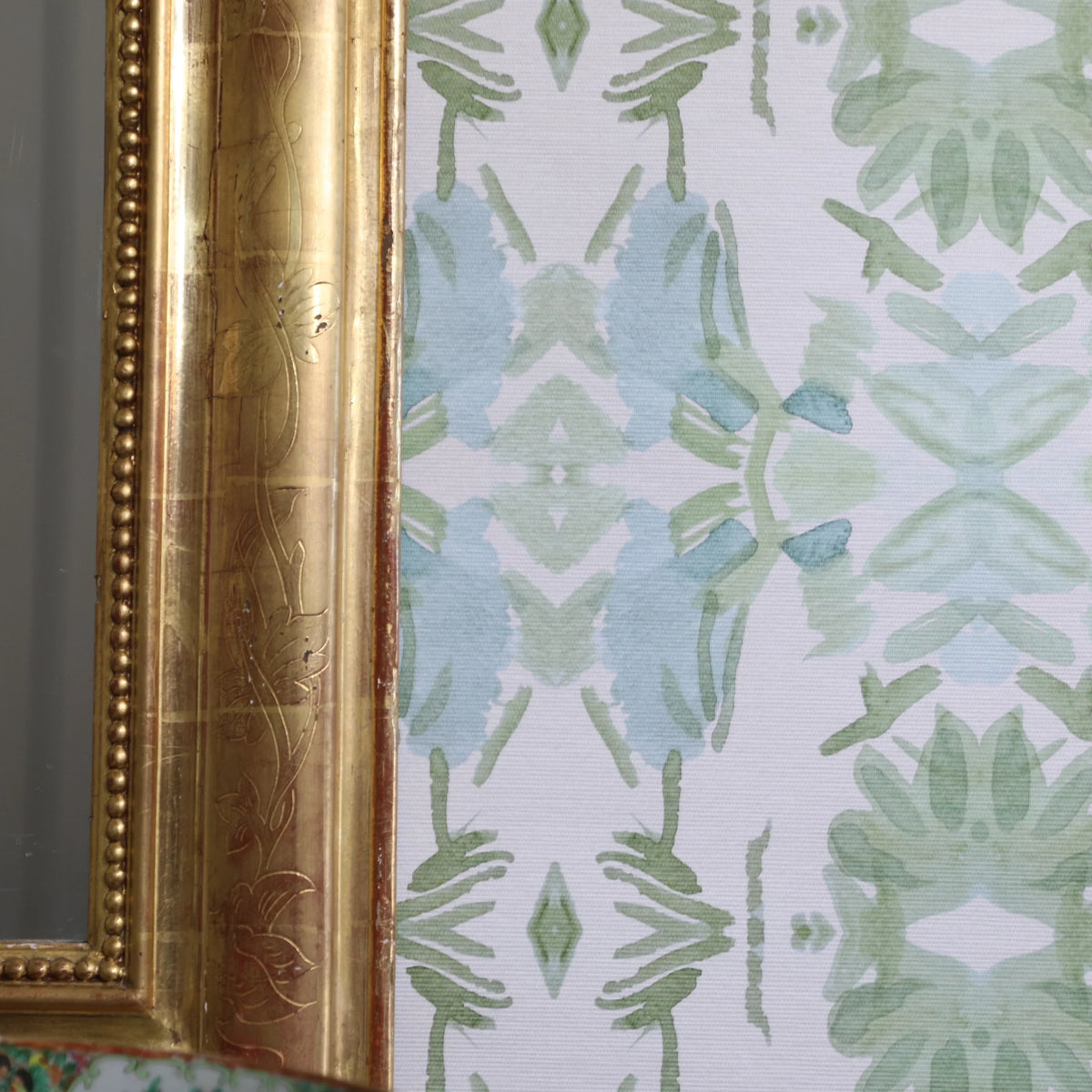 Luxury botanical wallpaper featuring an artistic wildflower-inspired pattern in sage green and soft blue, designed for modern traditional interiors, powder rooms, bedrooms, dining rooms, and collected homes.