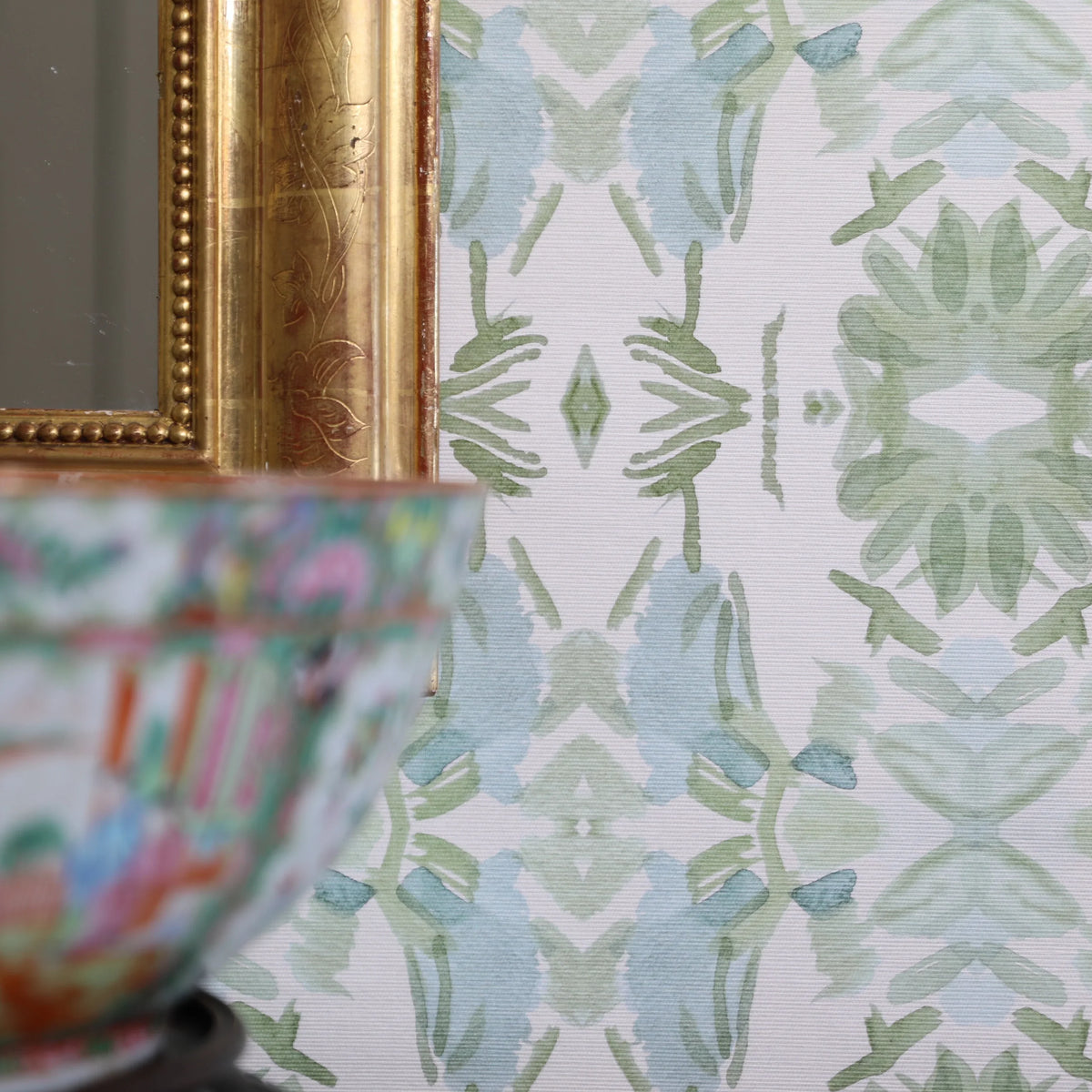 Luxury botanical wallpaper featuring an artistic wildflower-inspired pattern in sage green and soft blue, designed for modern traditional interiors, powder rooms, bedrooms, dining rooms, and collected homes.