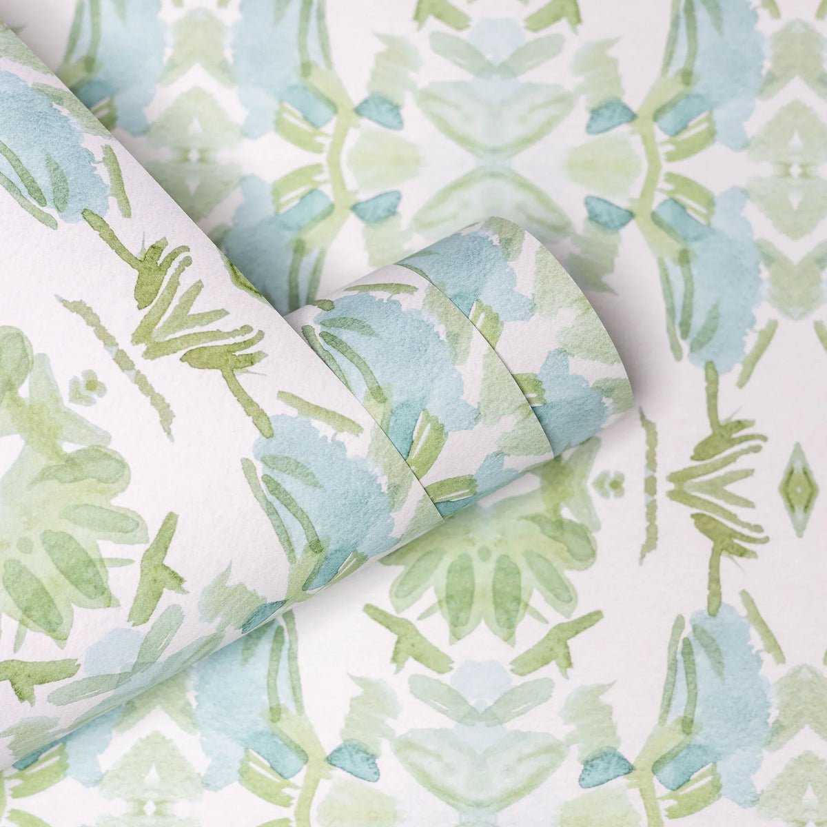 Luxury botanical wallpaper featuring an artistic wildflower-inspired pattern in sage green and soft blue, designed for modern traditional interiors, powder rooms, bedrooms, dining rooms, and collected homes.