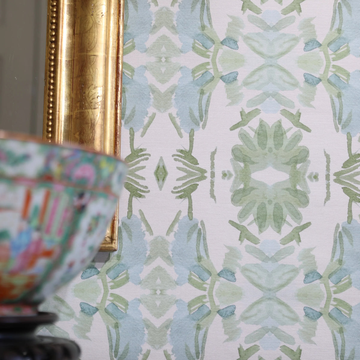Luxury botanical wallpaper featuring an artistic wildflower-inspired pattern in sage green and soft blue, designed for modern traditional interiors, powder rooms, bedrooms, dining rooms, and collected homes.