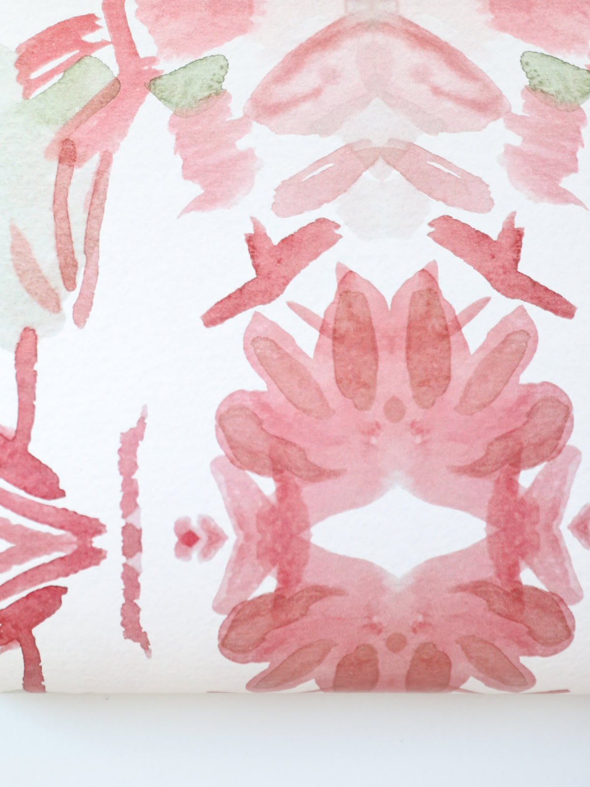 Luxury floral wallpaper featuring an artistic wildflower pattern in strawberry pink, blush, and soft green tones, designed for modern traditional interiors, bedrooms, powder rooms, and collected homes.
