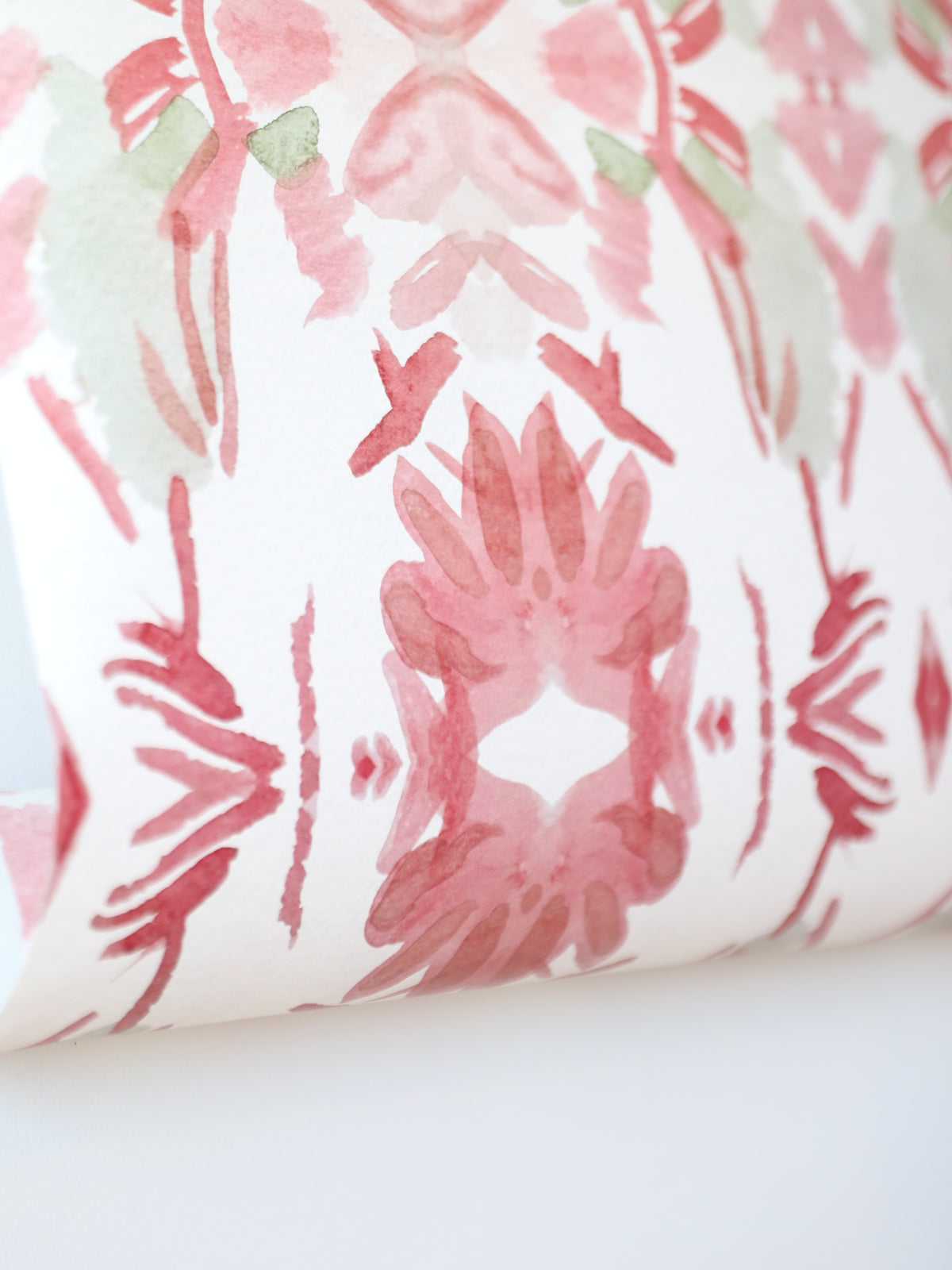 Luxury floral wallpaper featuring an artistic wildflower pattern in strawberry pink, blush, and soft green tones, designed for modern traditional interiors, bedrooms, powder rooms, and collected homes.