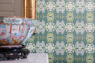 Luxury abstract floral wallpaper in rich dark green tones with layered organic movement, designed for modern traditional and collected interiors.